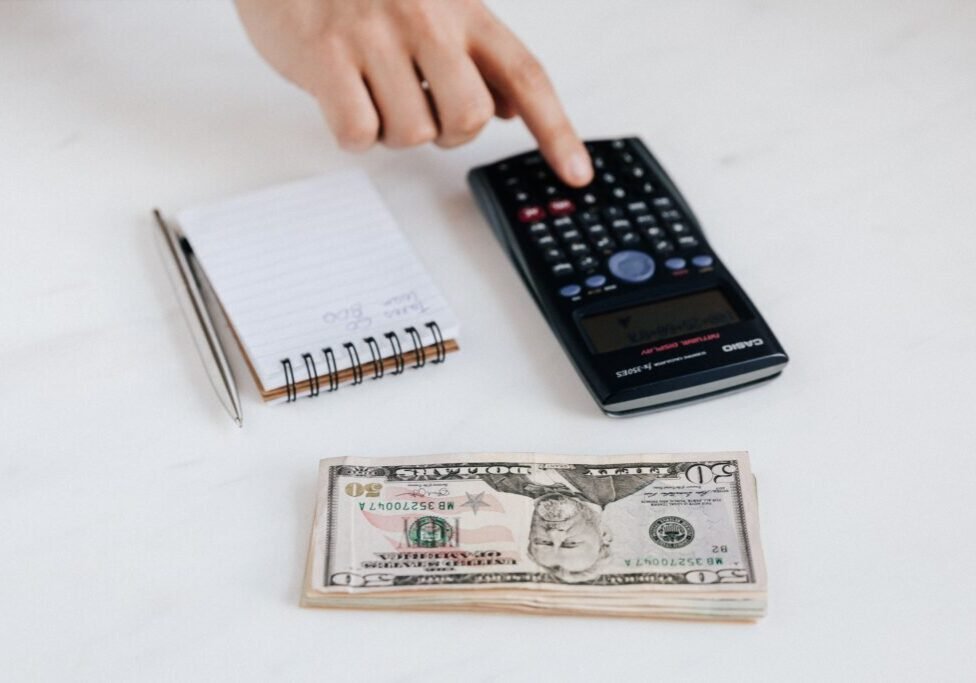 This <a href="https://www.pexels.com/photo/crop-unrecognizable-accountant-using-calculator-near-pile-of-american-dollars-4386322/">Photo</a> was taken by <a href="https://www.pexels.com/@karola-g">www.kaboompics.com</a> on Pexels.